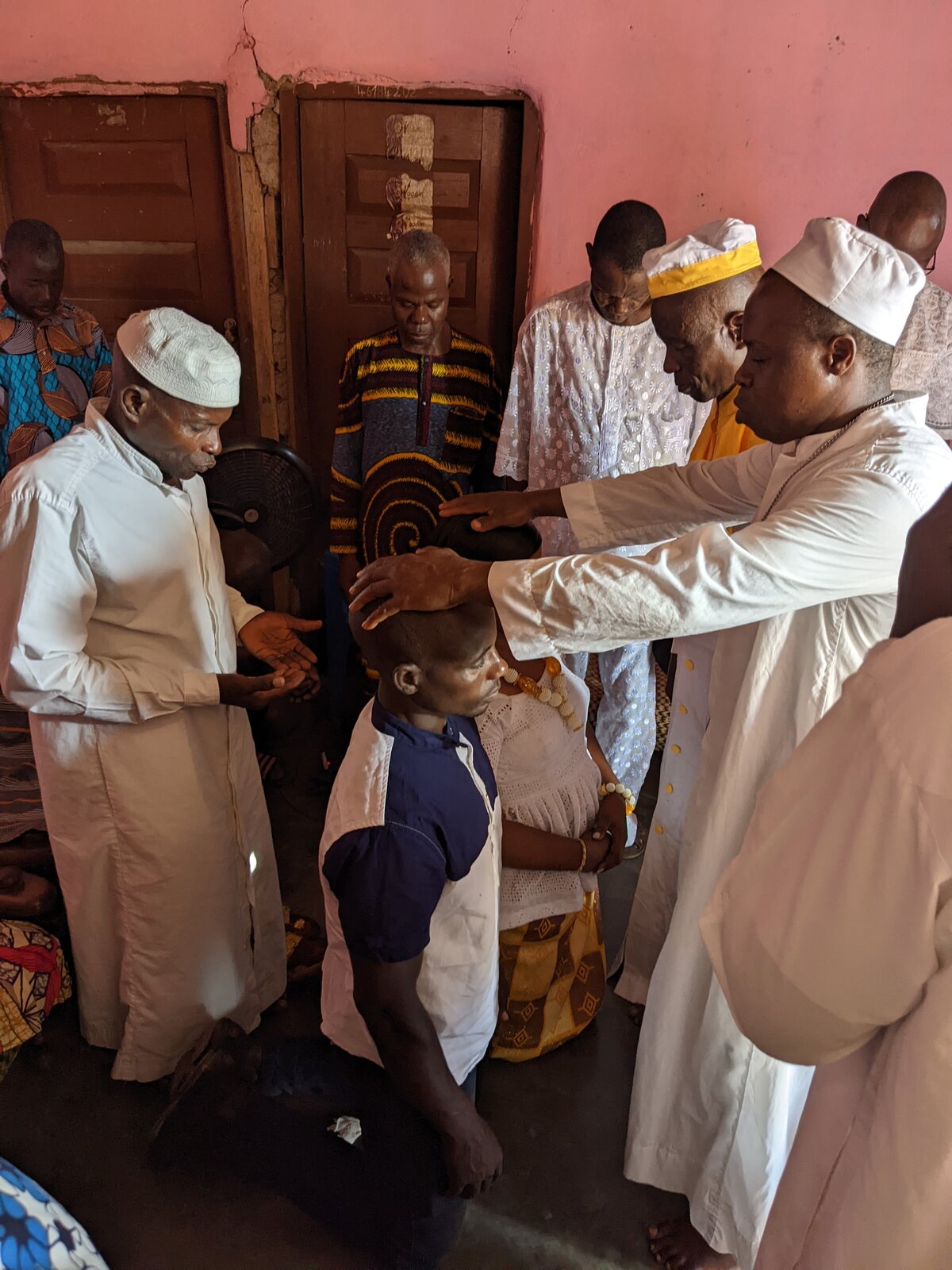 Religious leaders pray over the couple in the home of the bride's father